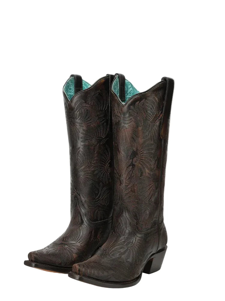 Pair of brown cowboy boots with turquoise lining on a white background