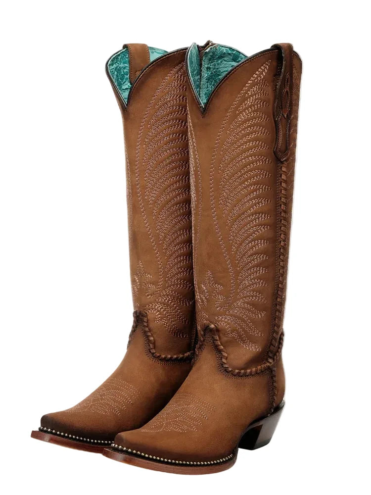 Brown cowboy boots with turquoise lining on a white background