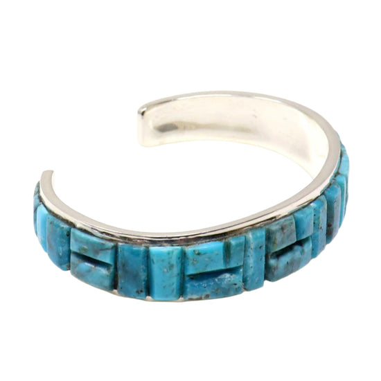 Turquoise inlay ring with silver band on a white background