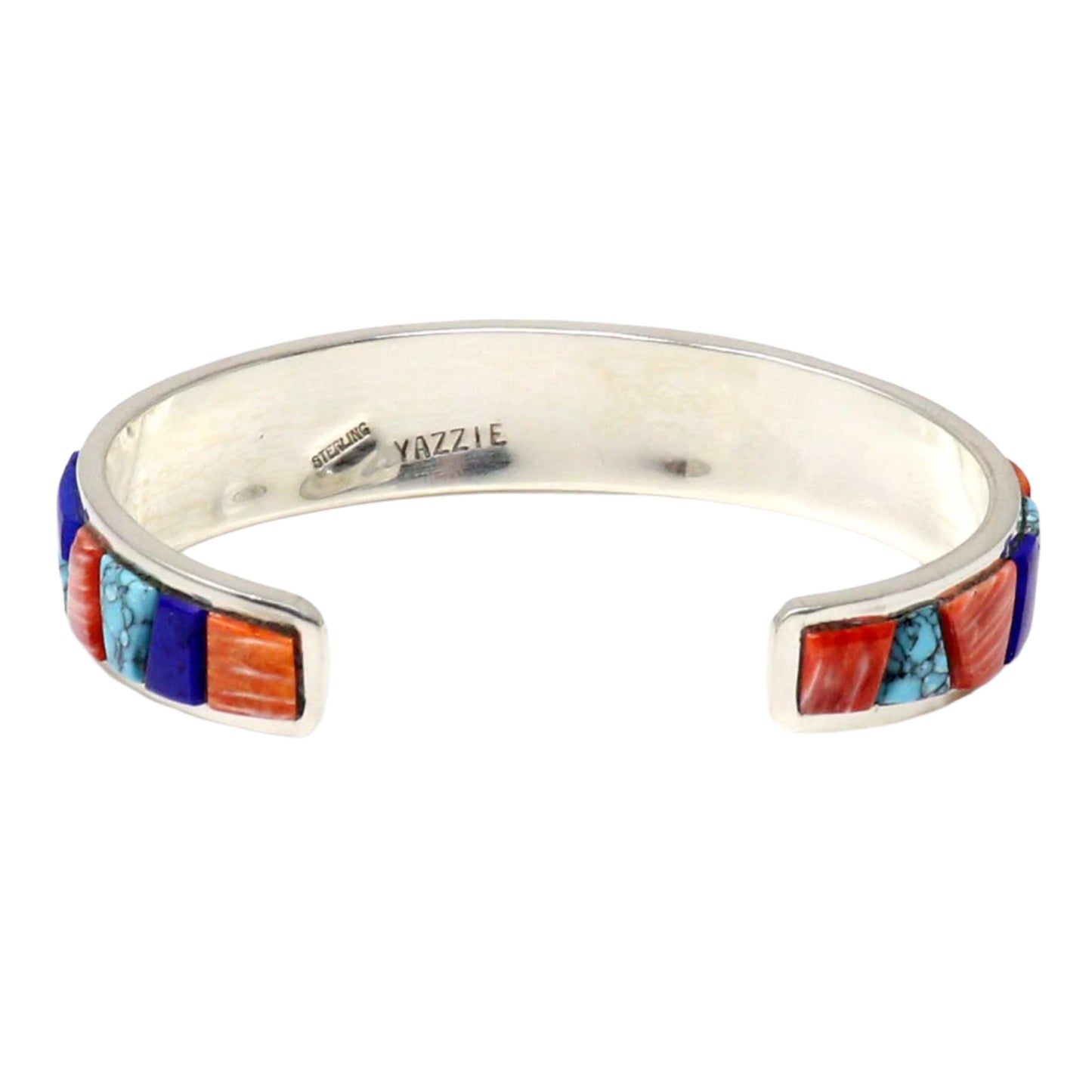 Silver bracelet with colorful stone inlay on a white background