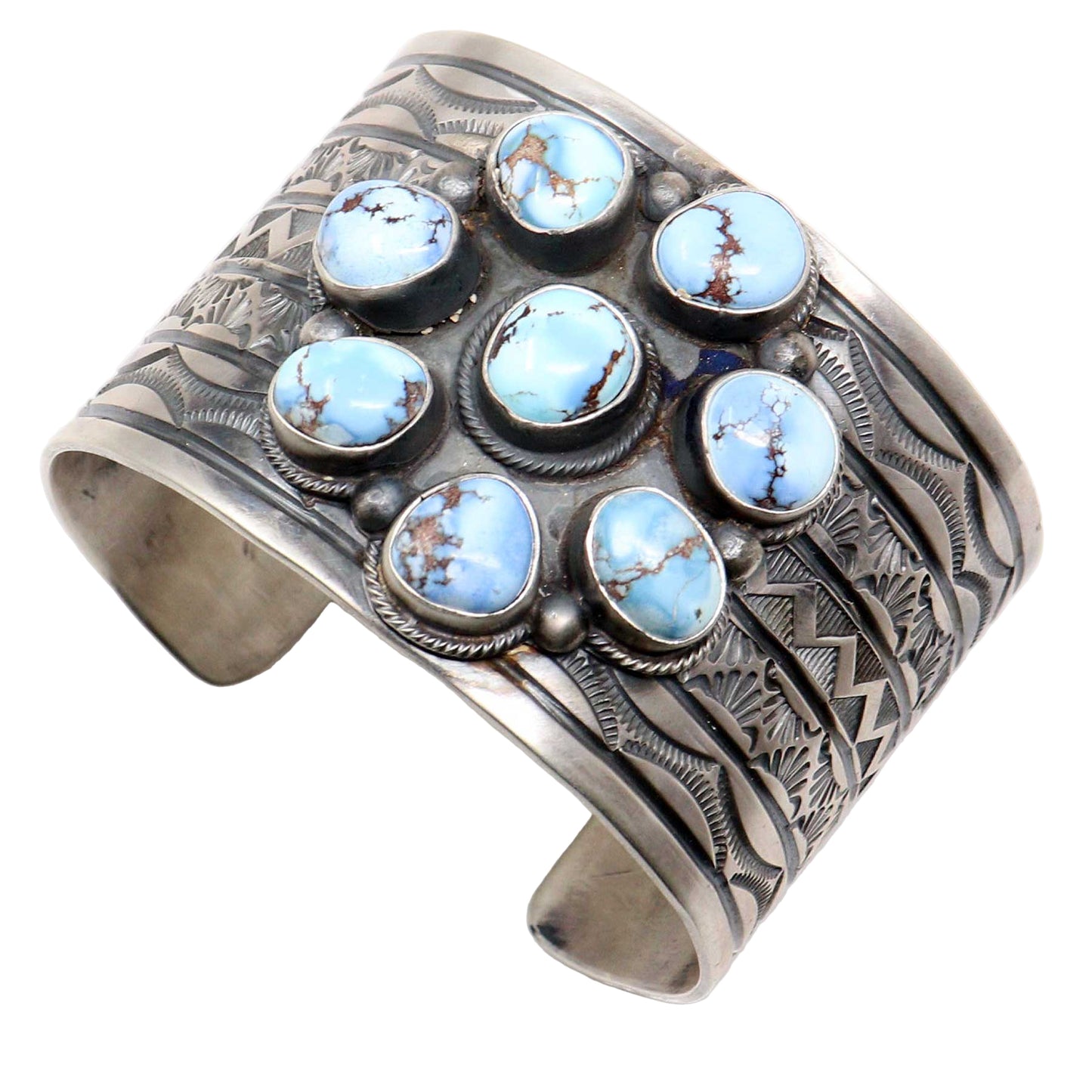 Silver cuff bracelet with turquoise stones on a white background