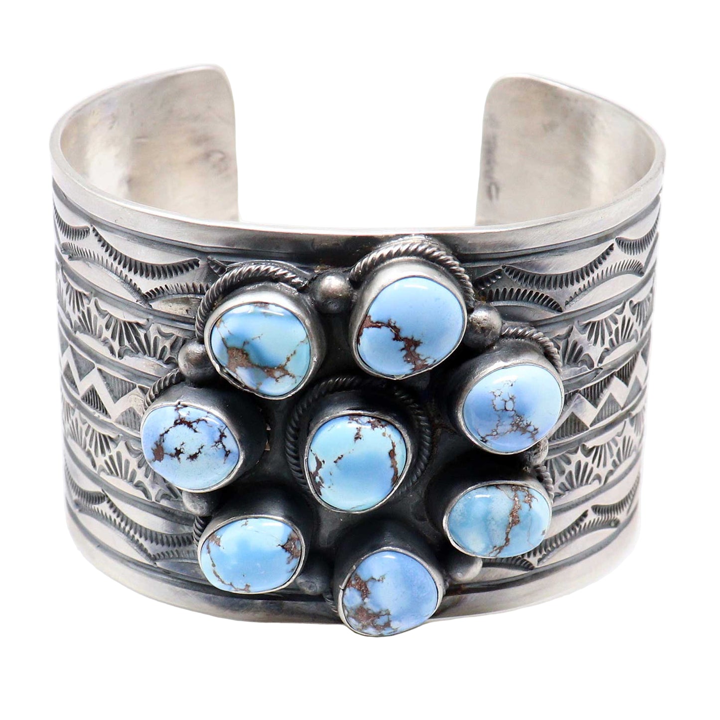 Silver cuff bracelet with blue stone accents on a white background