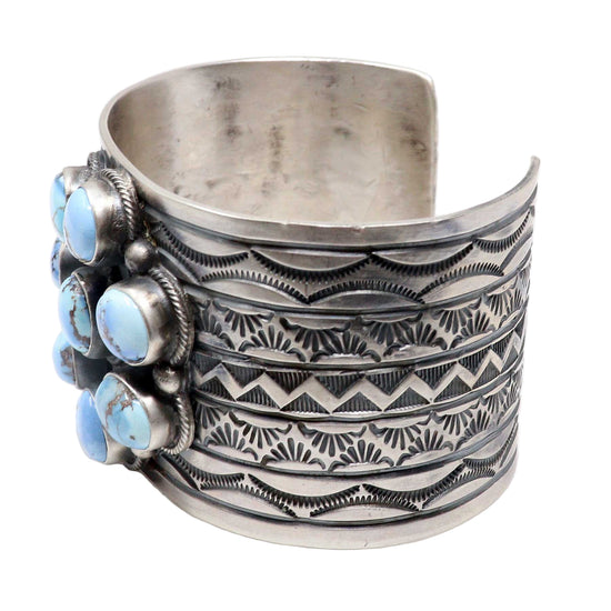 Silver cuff bracelet with blue stone accents on a white background
