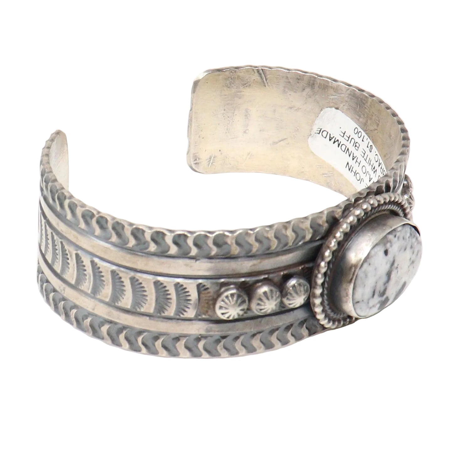 Silver bracelet with intricate designs on a white background