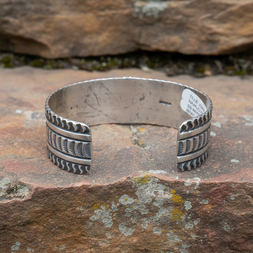 Cuff bracelet with tribal design on a white background