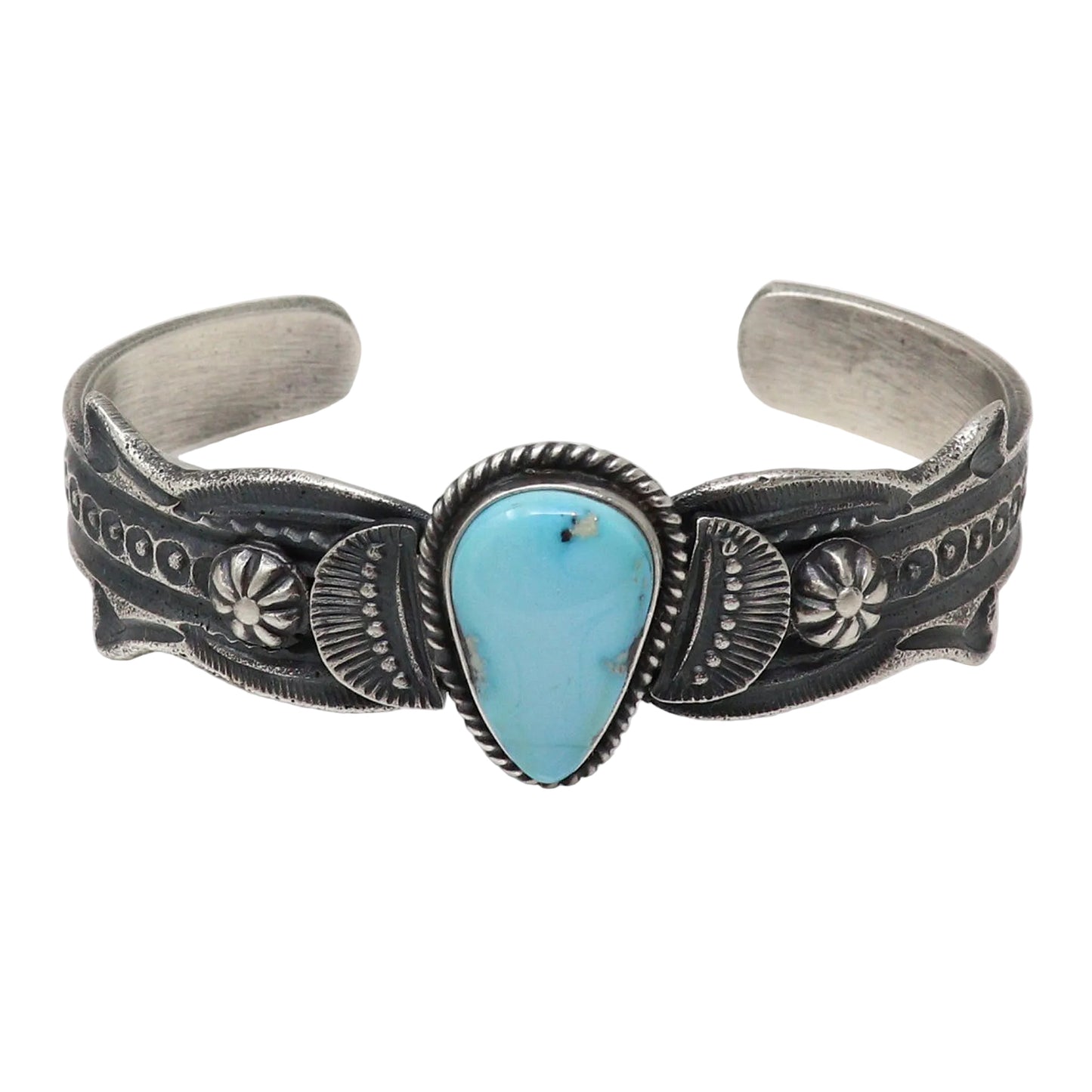 A sterling silver cuff bracelet featuring a central turquoise stone cabochon, photographed on a clean white background.