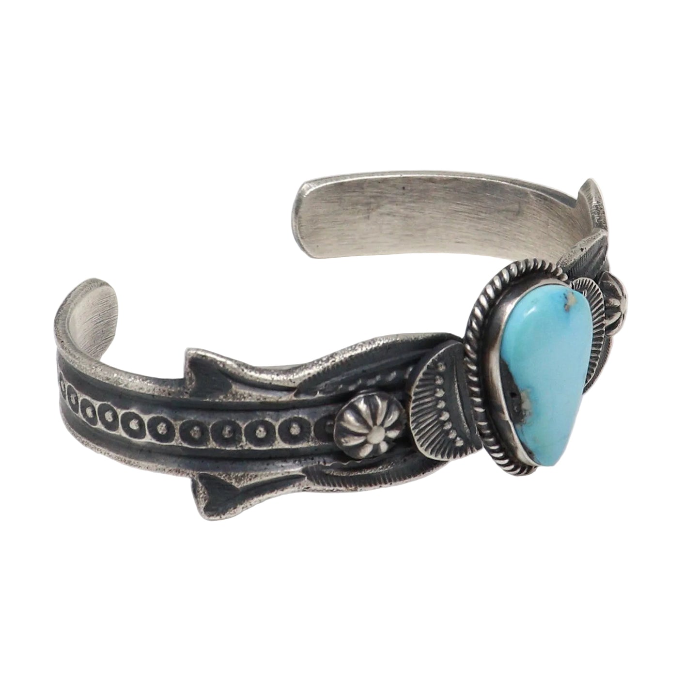 A sterling silver cuff bracelet featuring a turquoise stone in a bezel setting, photographed on a clean white background.