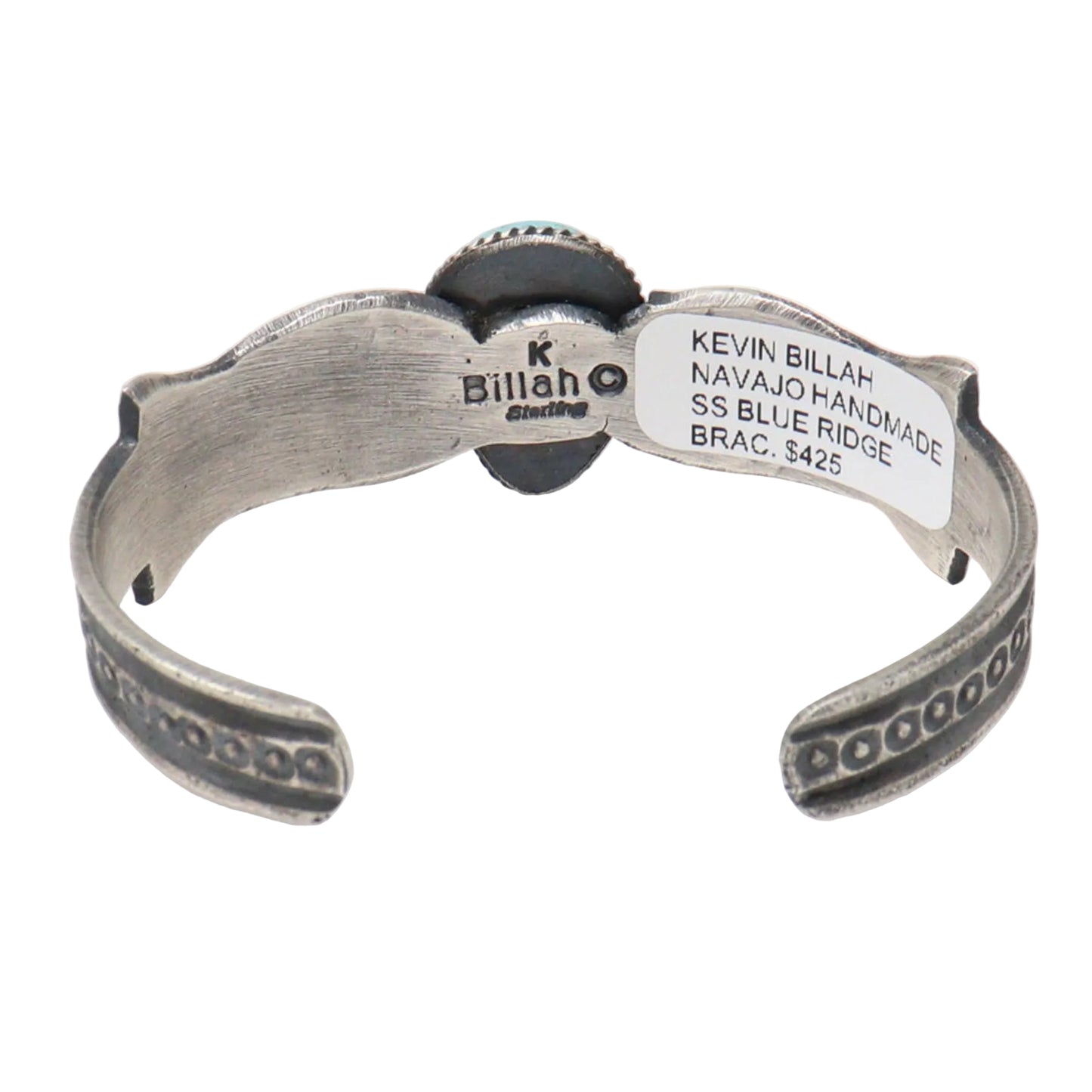 A sterling silver Navajo cuff bracelet by Kevin Billah, featuring hand-hammered details, a round turquoise stone, and a white inventory tag on a white background.