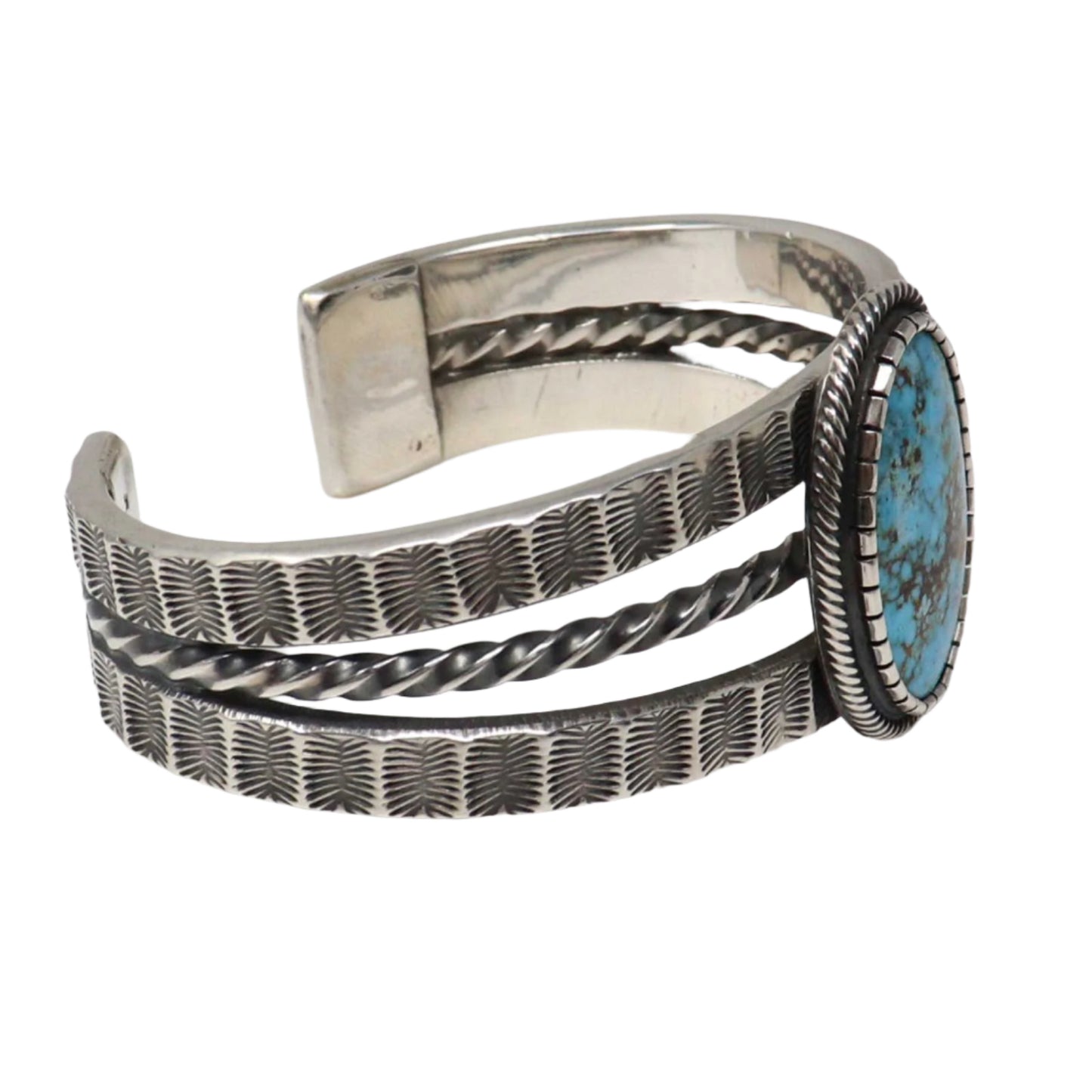 Silver bracelet with turquoise stone on a light gray background