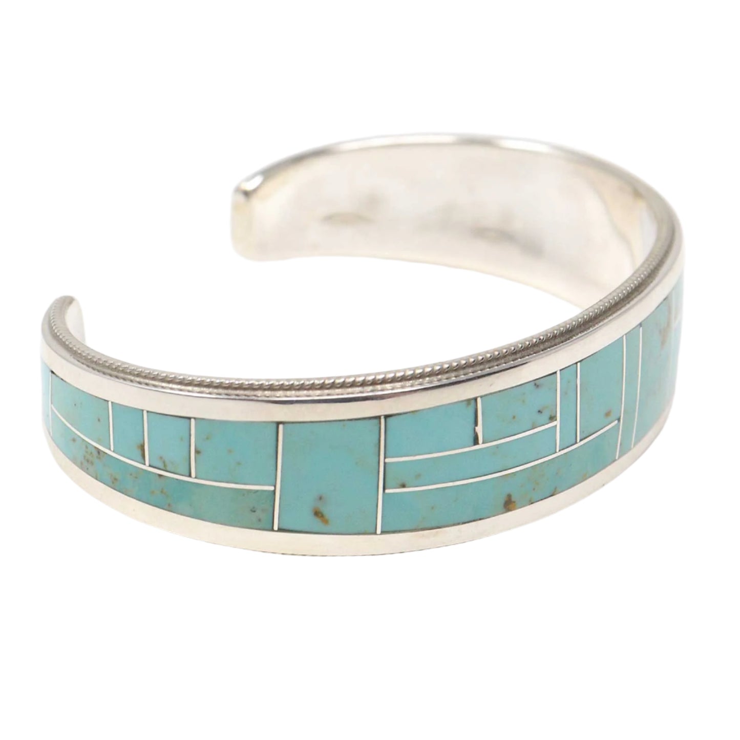 Silver bracelet with turquoise inlay on a white background
