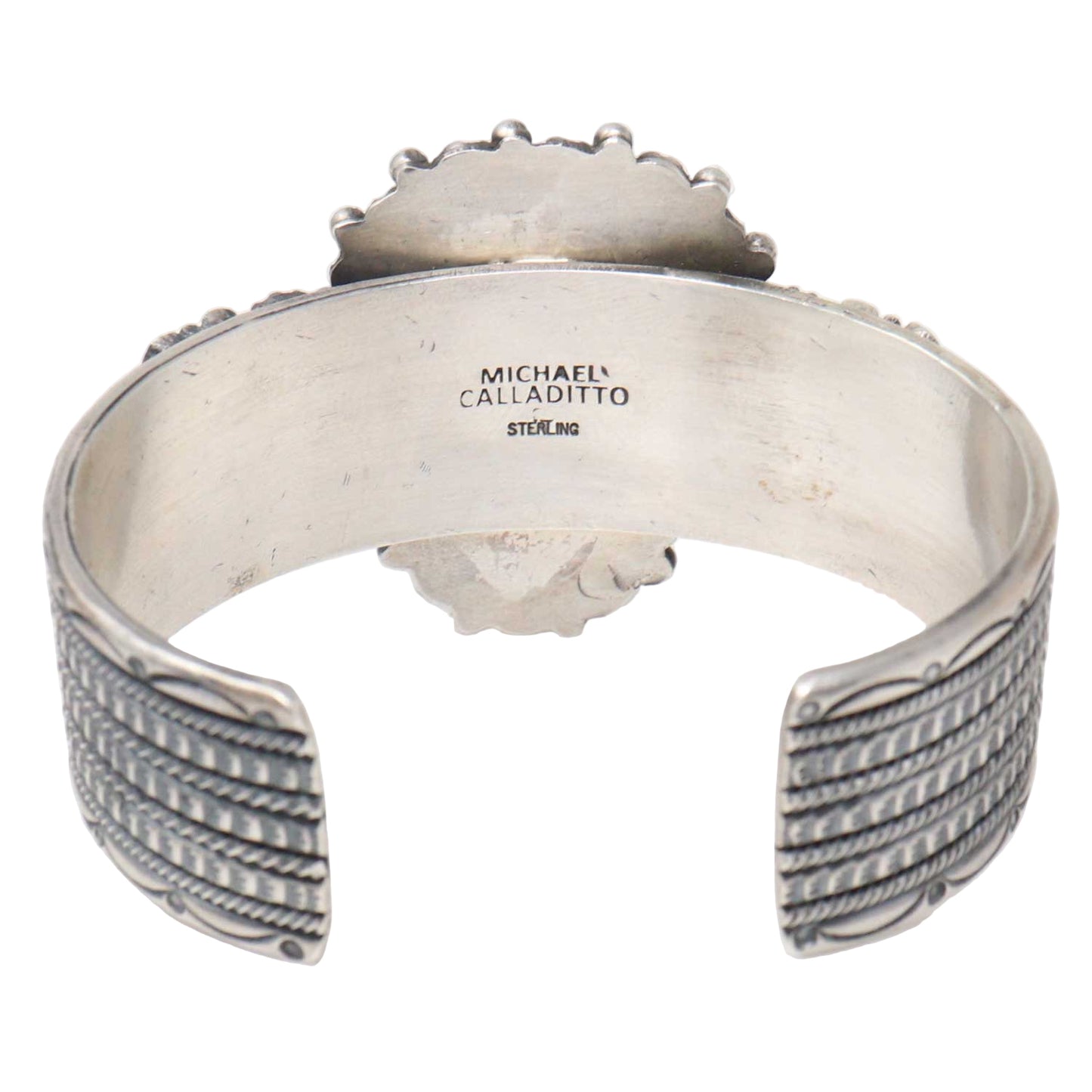 Silver bracelet with 'Michael Calladitto' engraving on a white background