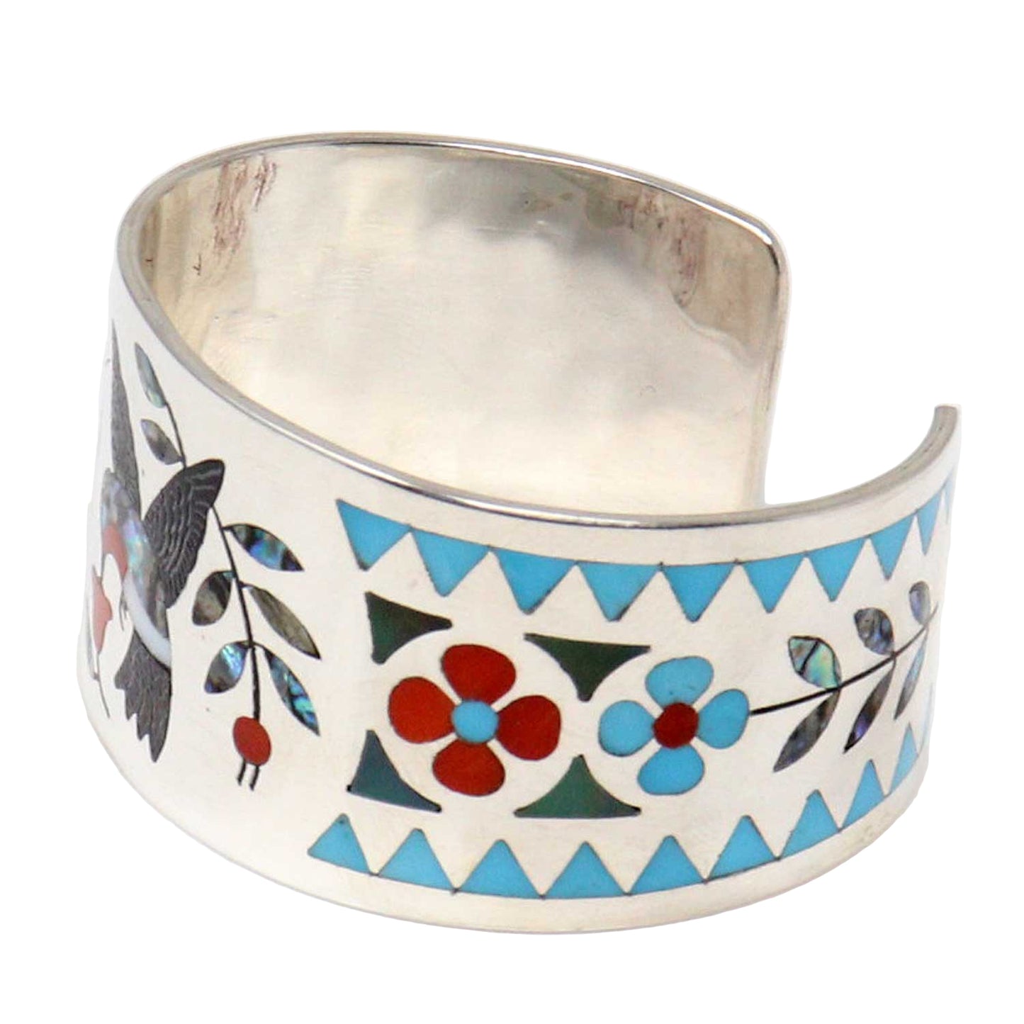 Silver cuff bracelet with colorful geometric and floral patterns on a white background
