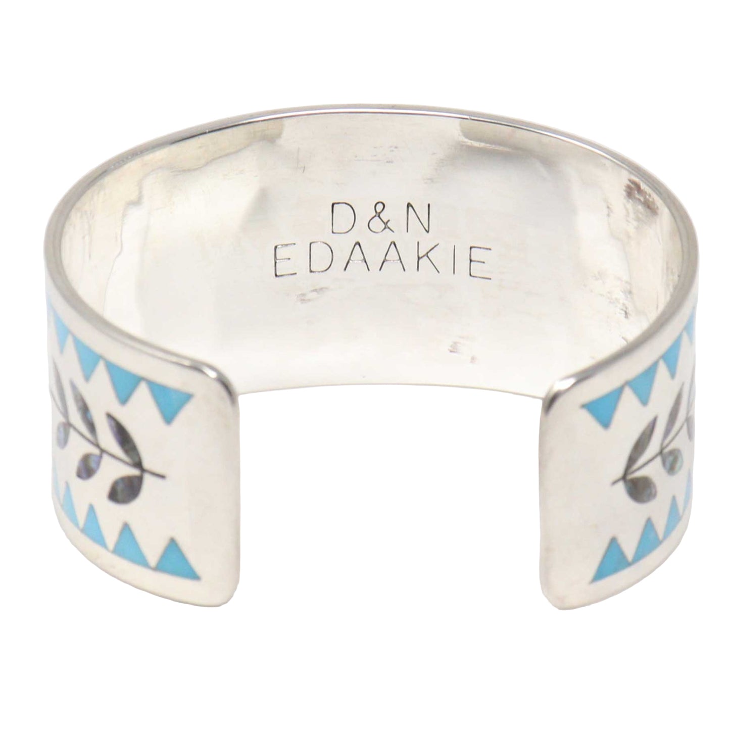 Silver bracelet with blue and black patterns on a white background