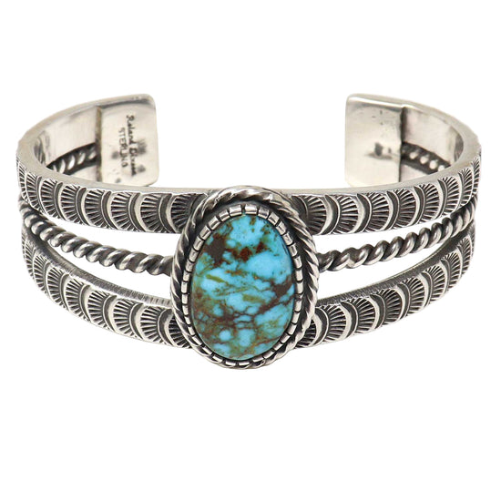 Silver bracelet with turquoise stone on a white background