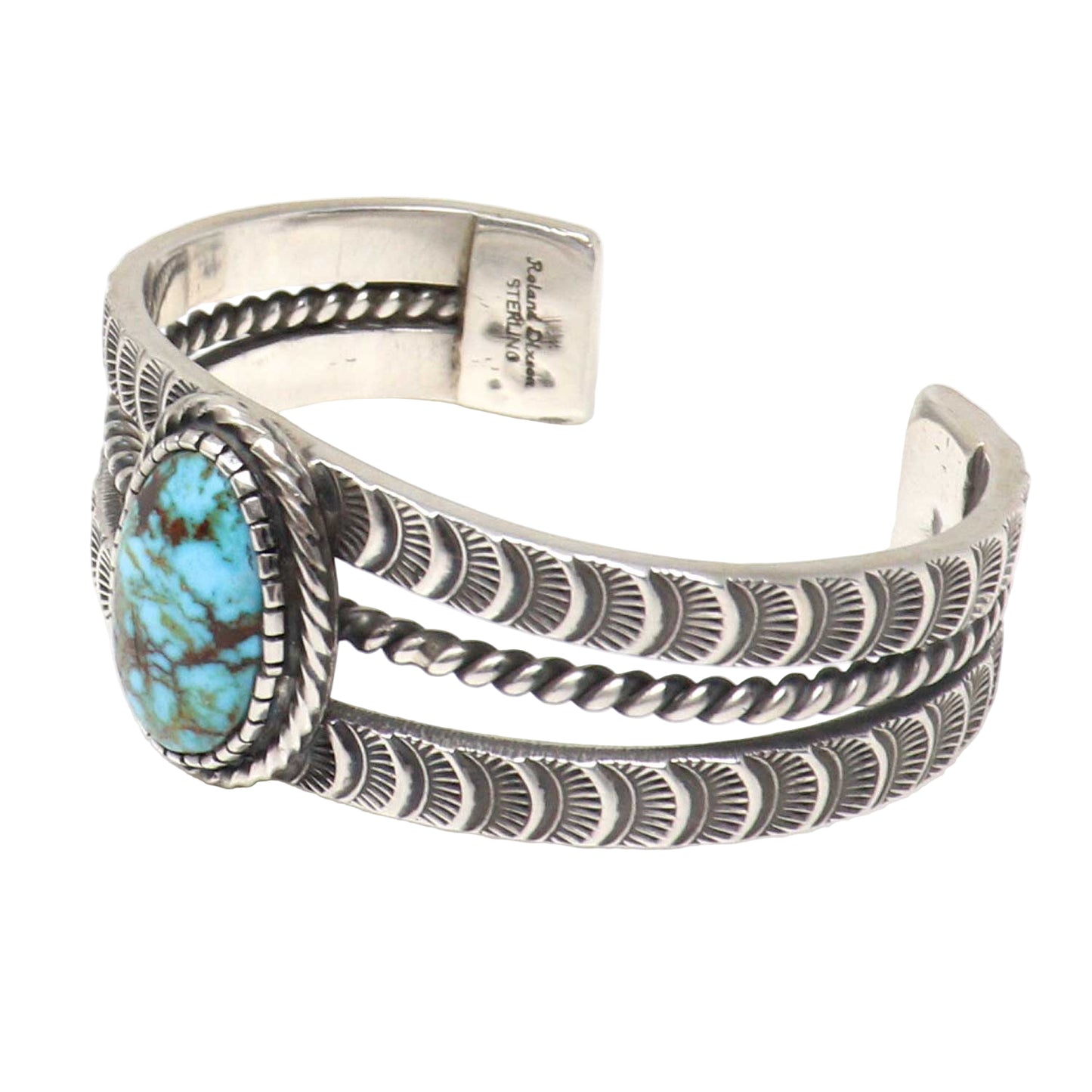 Silver cuff bracelet with turquoise stone on a white background