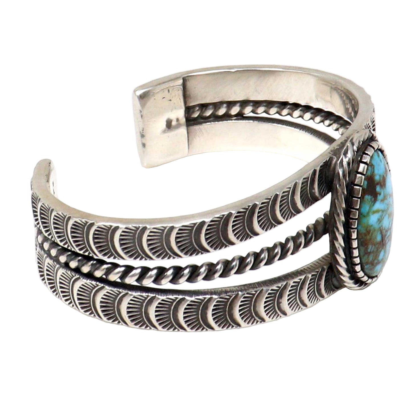 Silver bracelet with turquoise stone on a white background