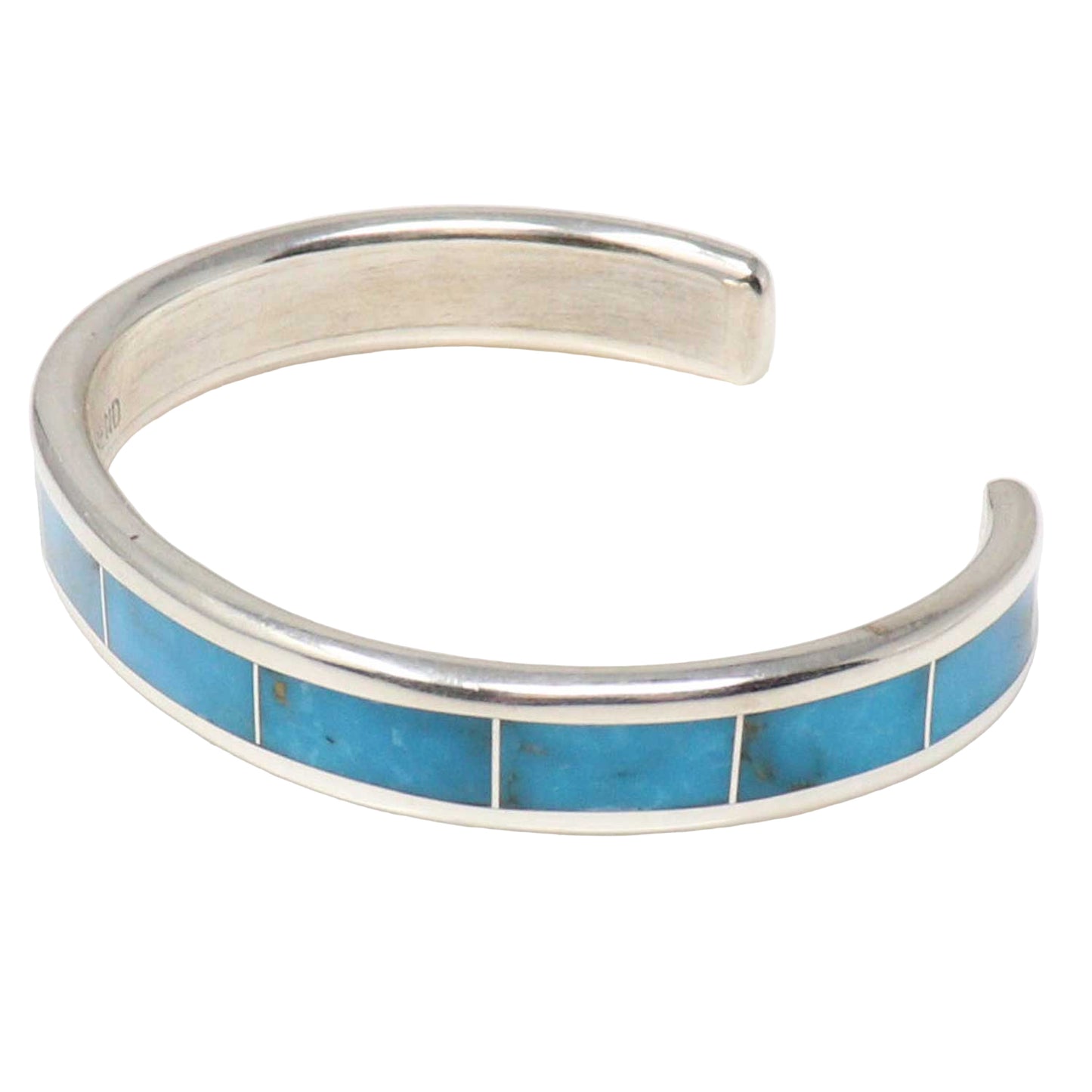 Silver bracelet with blue inlay on a white background