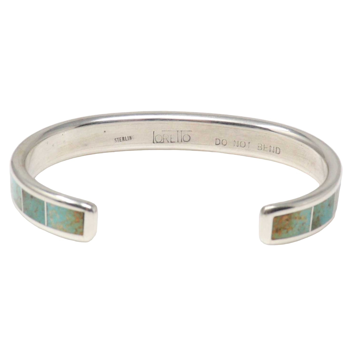 Silver bracelet with turquoise inlay on a white background