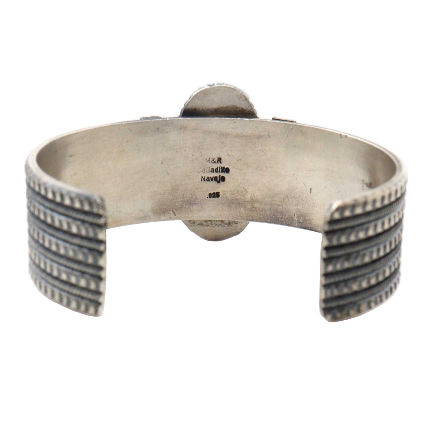 Silver bracelet with textured design on a white background