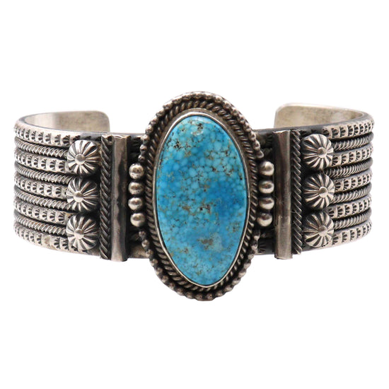Silver bracelet with a turquoise stone on a white background