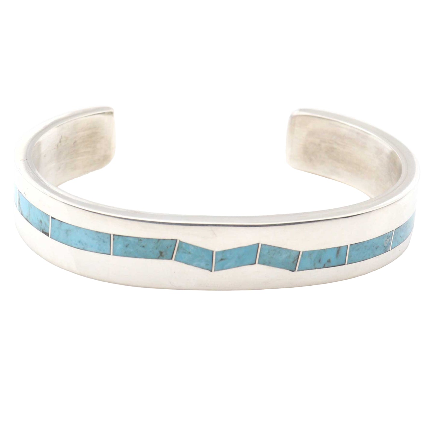 Silver cuff bracelet with turquoise inlay on a white background