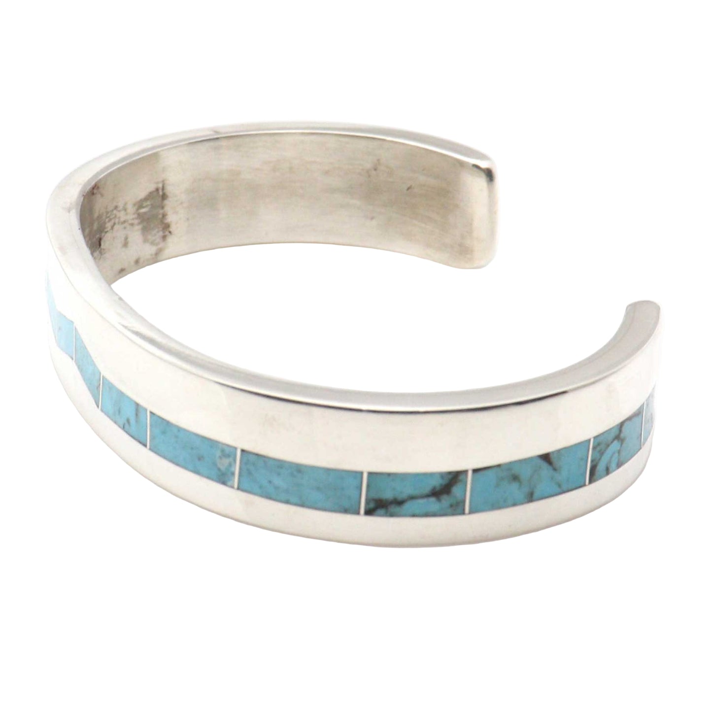 Silver bracelet with turquoise inlay on a white background