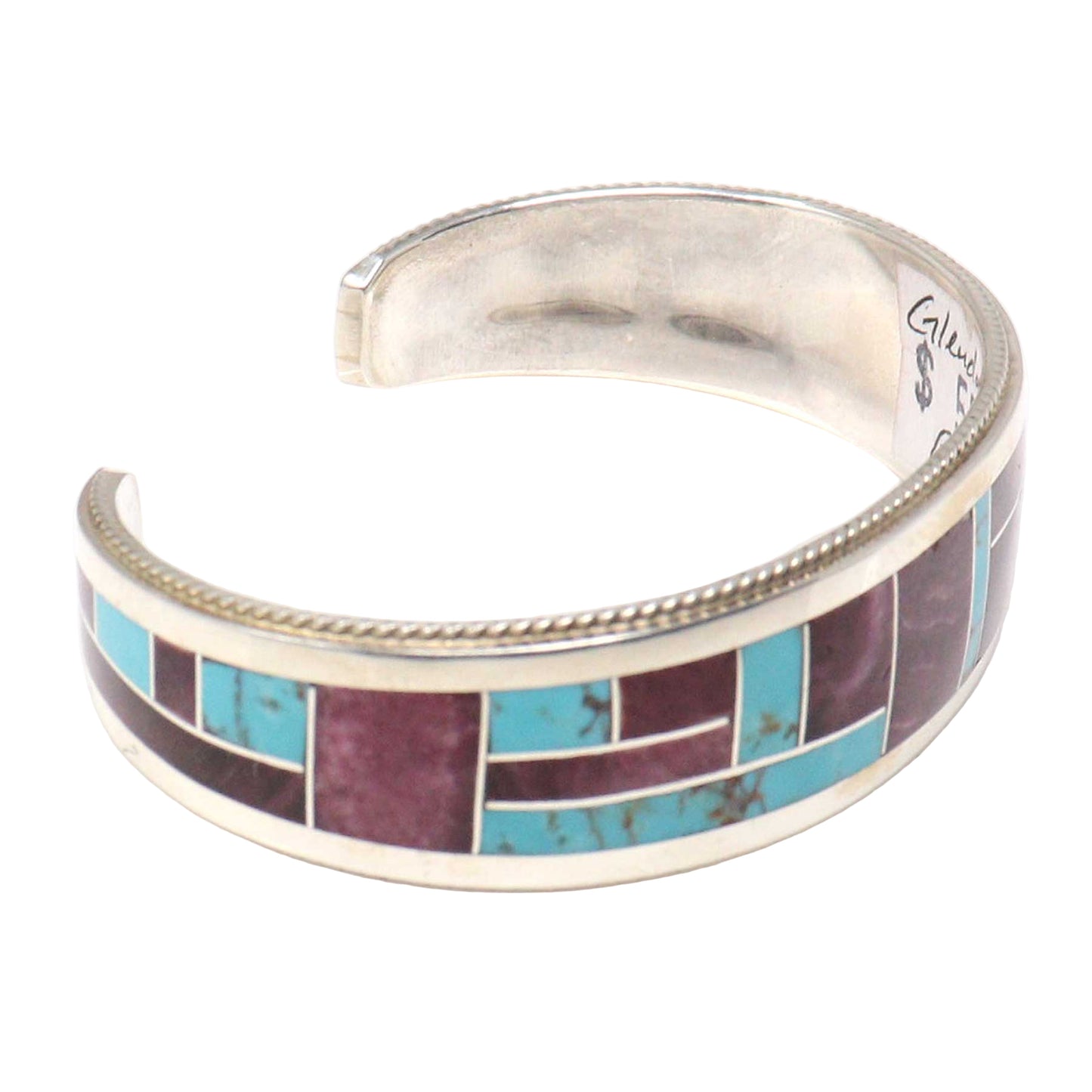 Silver bracelet with purple and turquoise inlay on a white background