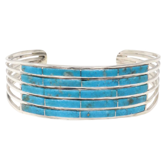 Silver bracelet with turquoise stones on a white background