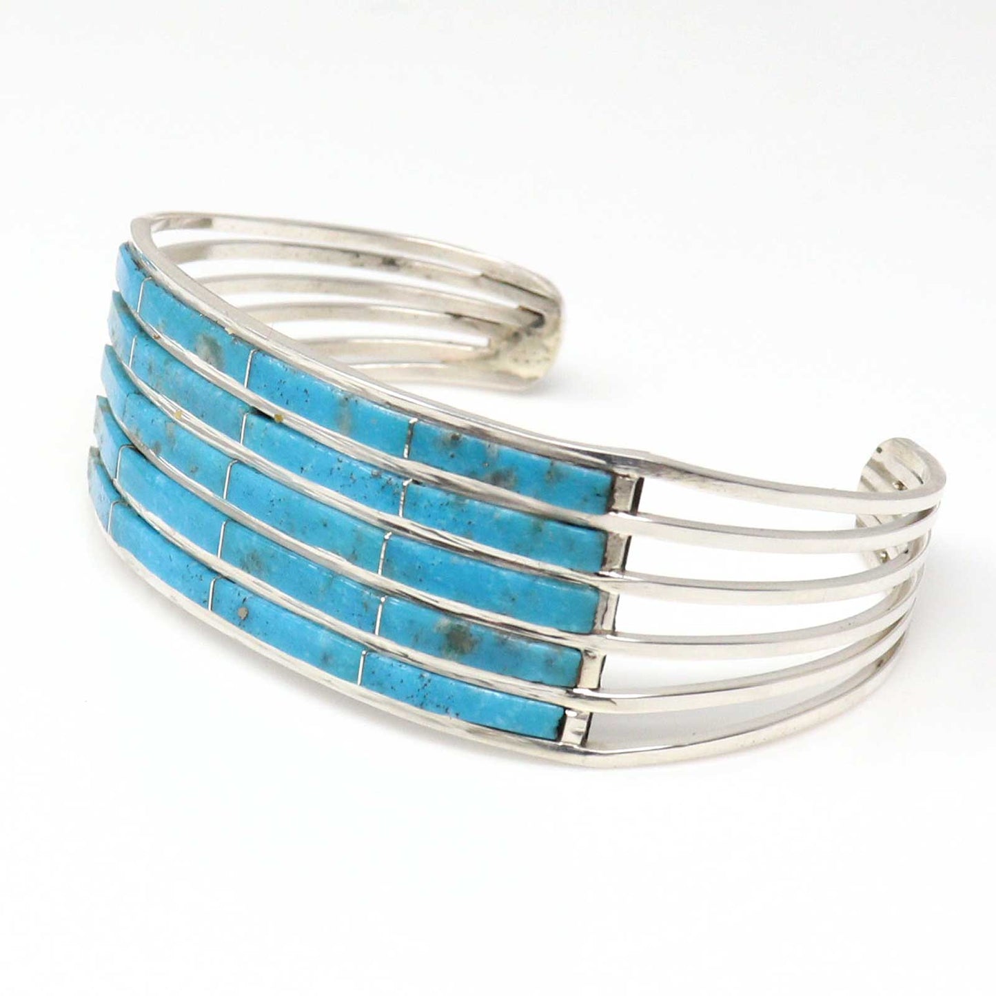 Silver bracelet with turquoise inlay on a white background