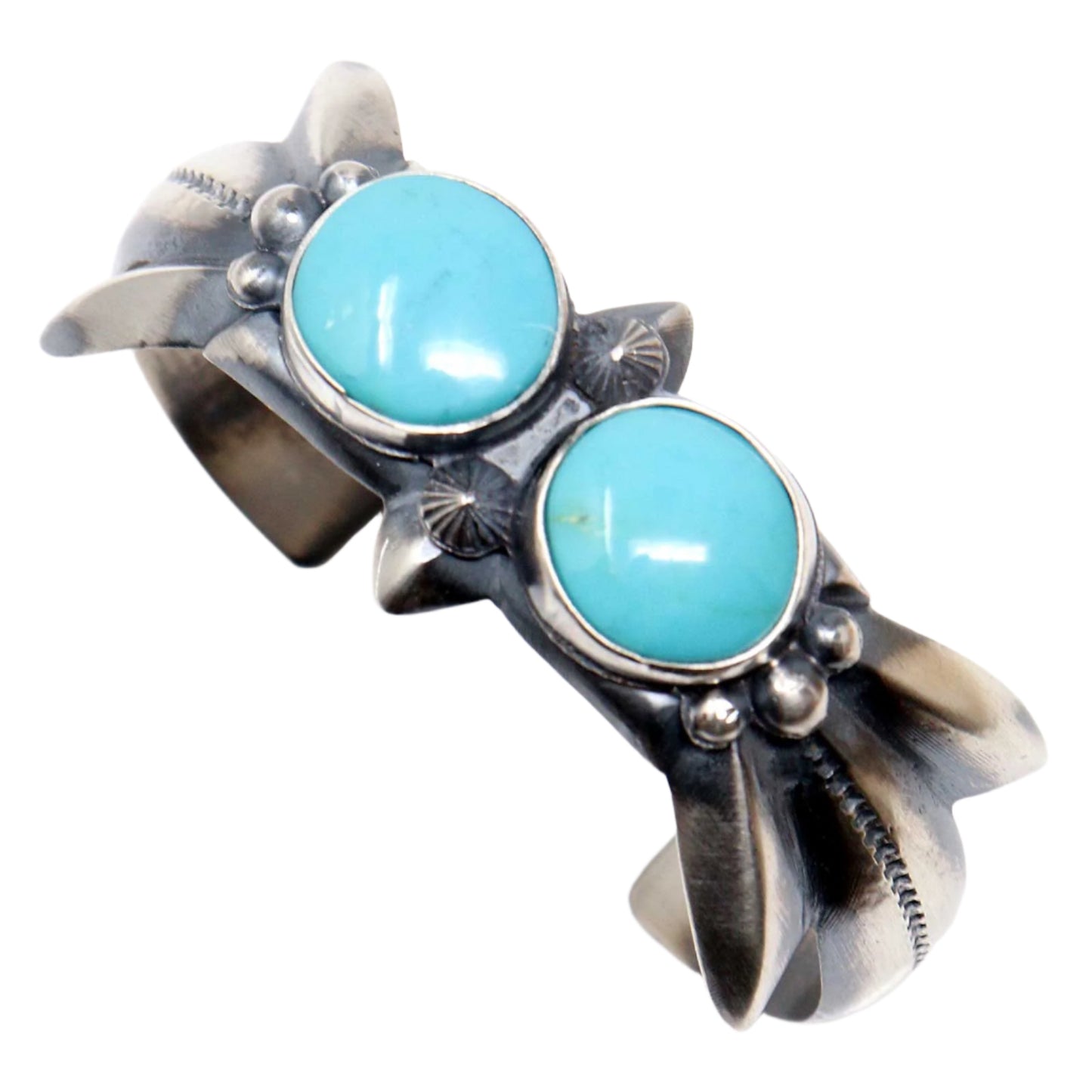 Silver bracelet with turquoise stones on a white background