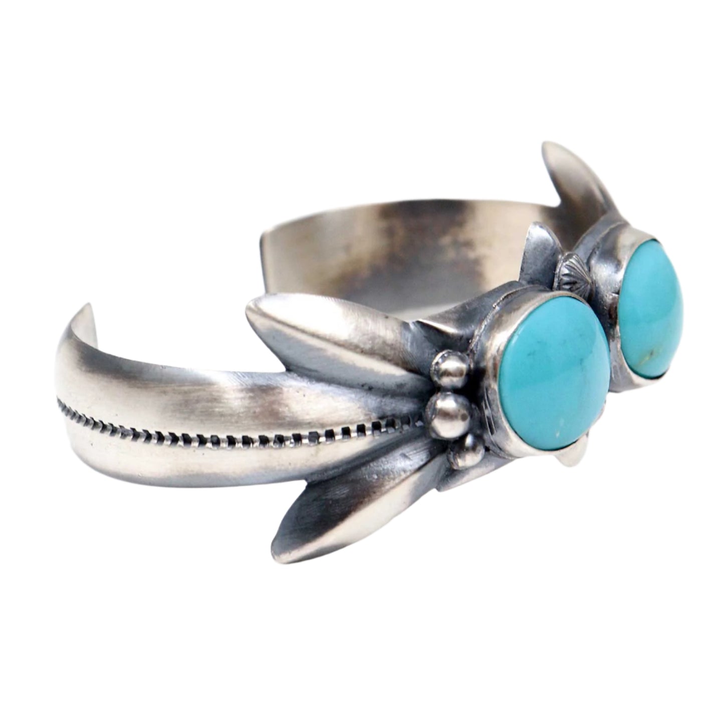 Silver bracelet with turquoise stones on a white background