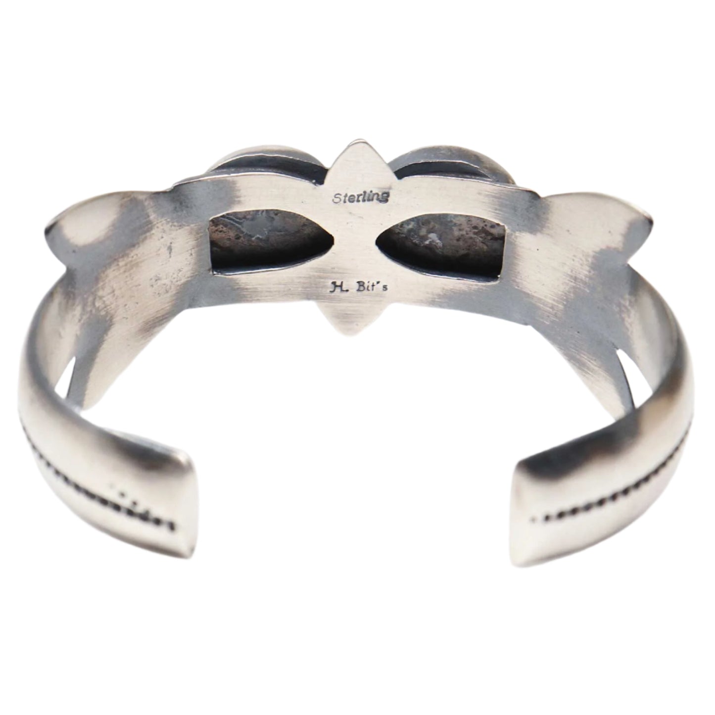 Silver bracelet with a bow design on a white background