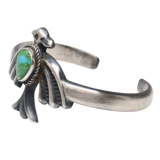 Silver bracelet with a turquoise stone on a white background