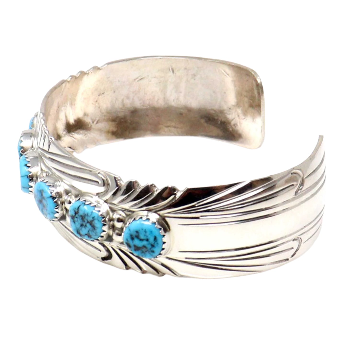 Silver bracelet with turquoise stones on a white background