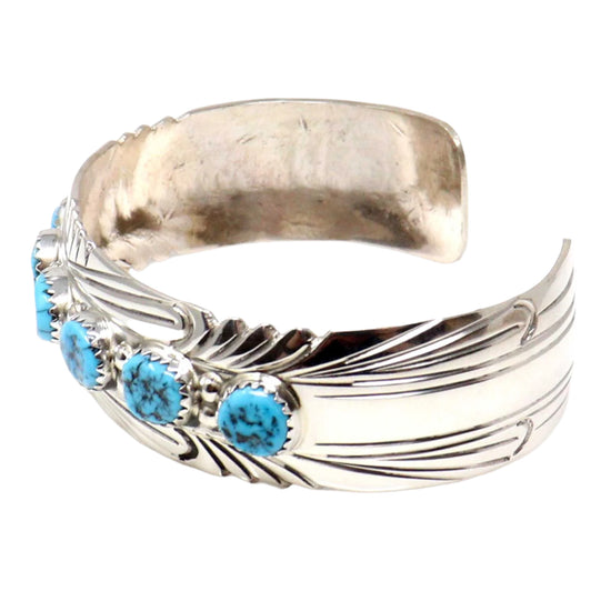 Silver bracelet with turquoise stones on a white background