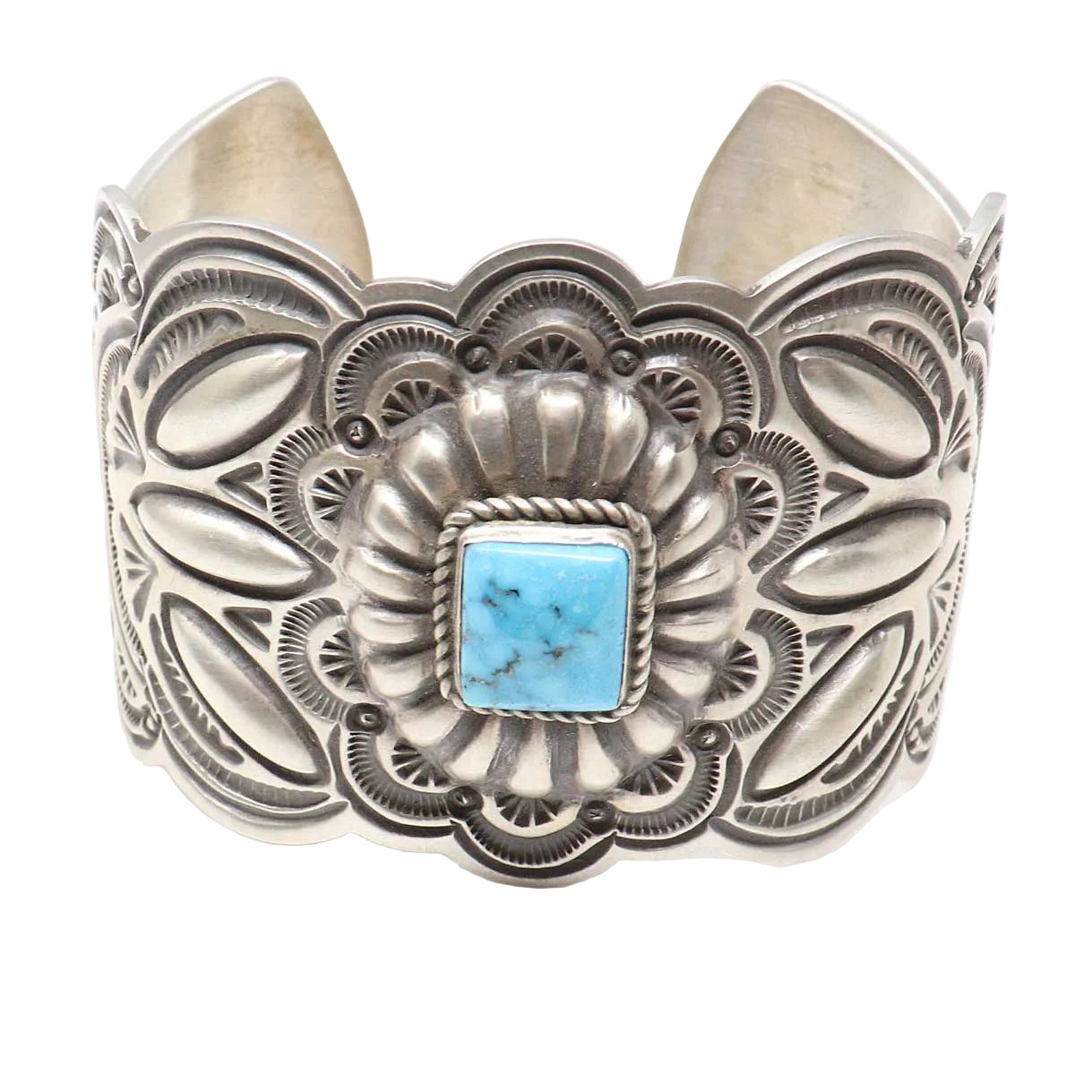 Silver cuff bracelet with turquoise stone on a white background