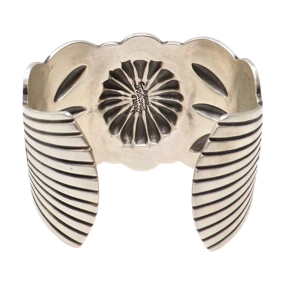 Silver bracelet with floral design on a white background