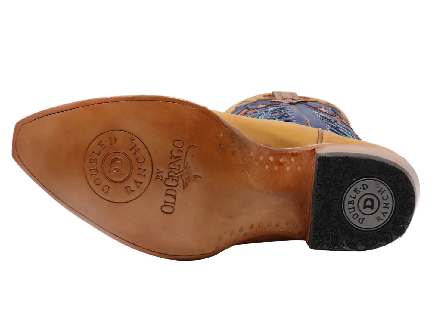 The sole of a cowboy boot is shown from a side angle, featuring a tan leather insole embossed with 'OLD GINGO' and 'DOUBLE RANCH', a black rubber outsole, and a glimpse of a blue and multicolor patterned shaft.