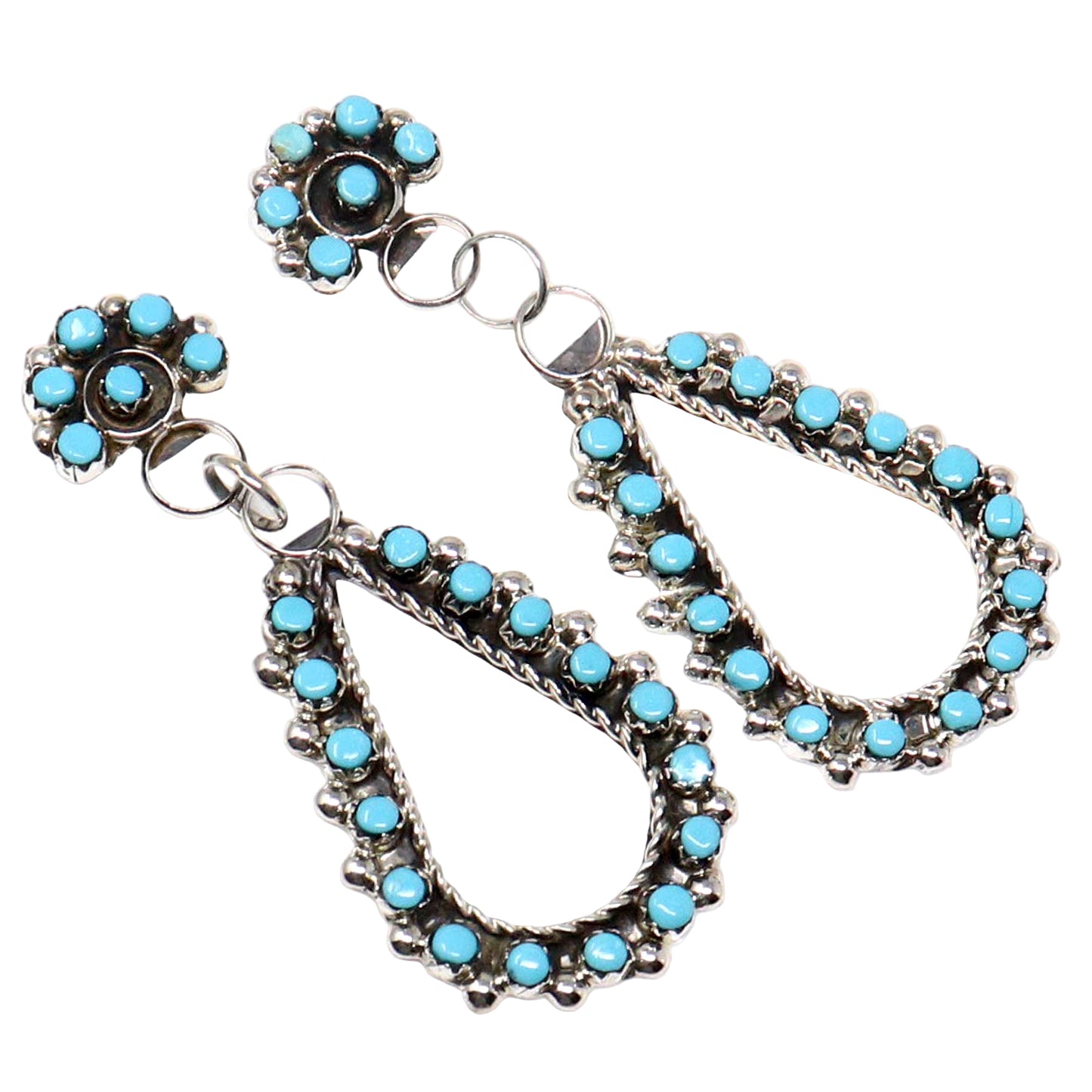 Pair of earrings with turquoise stones on a white background