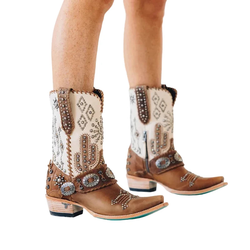 Decorative cowboy boots with intricate patterns and embellishments on a light background