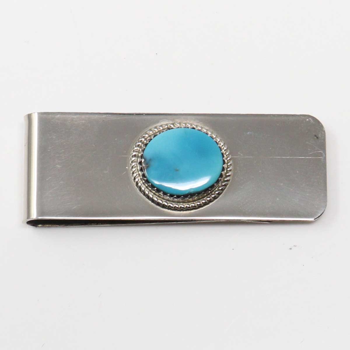 Silver money clip with a turquoise stone on a white background