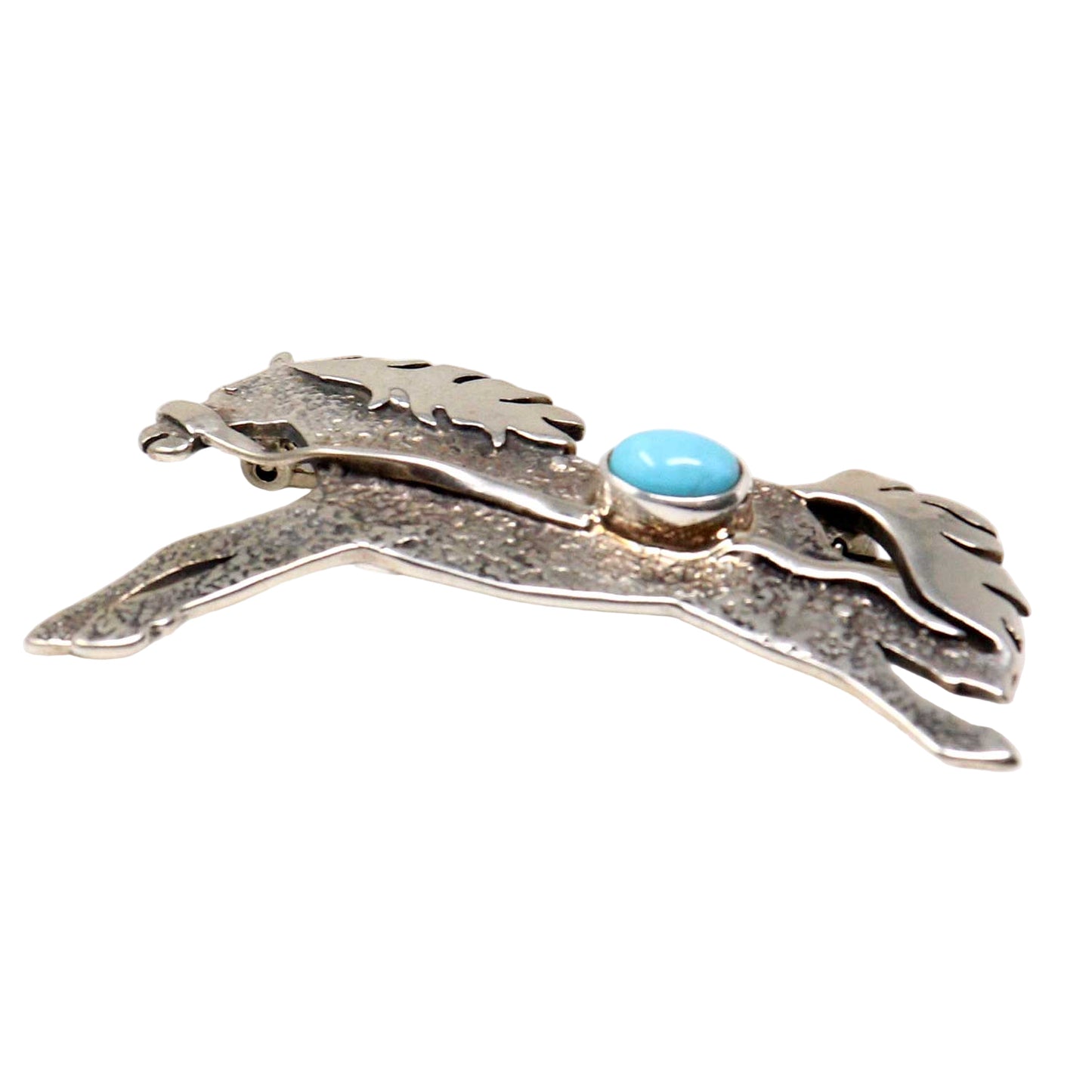 Silver brooch with a turquoise stone on a white background