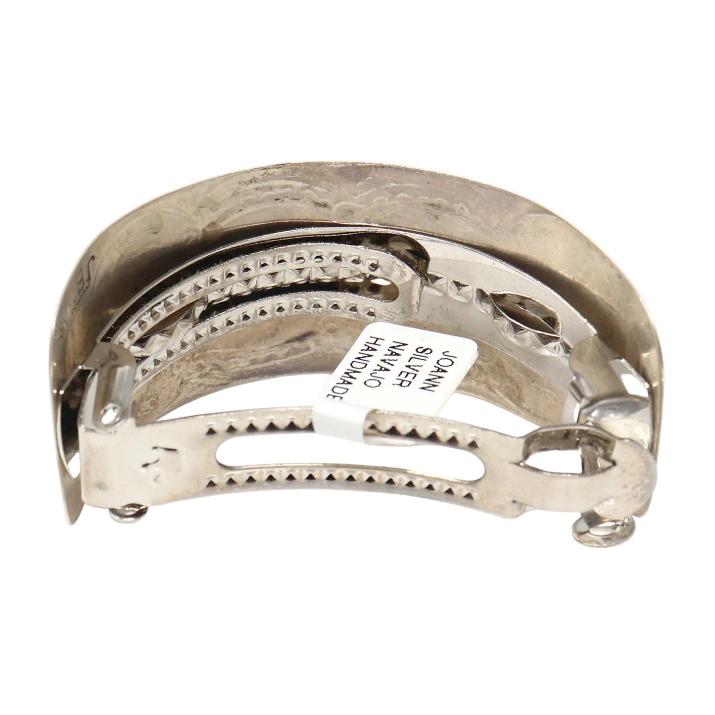 Silver hair clip with engraved design on a white background