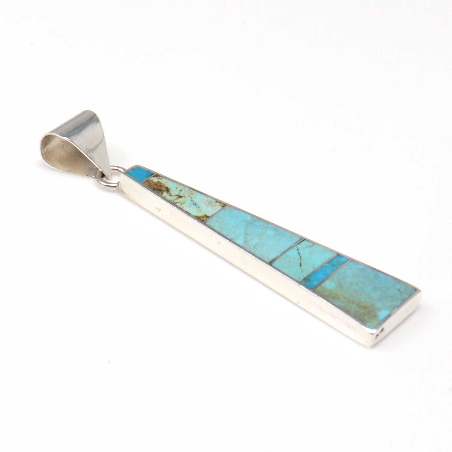 Turquoise inlay pendant on a white background