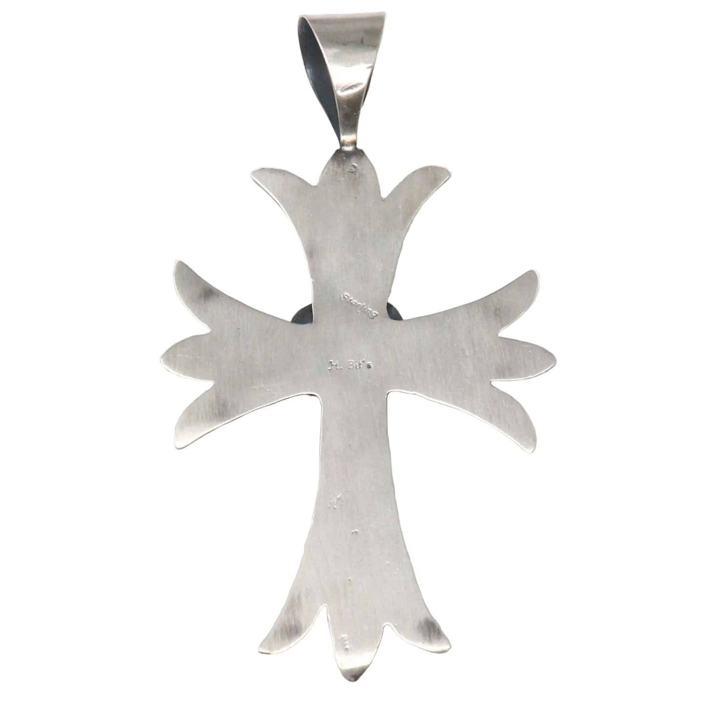 Silver cross pendant on a white background