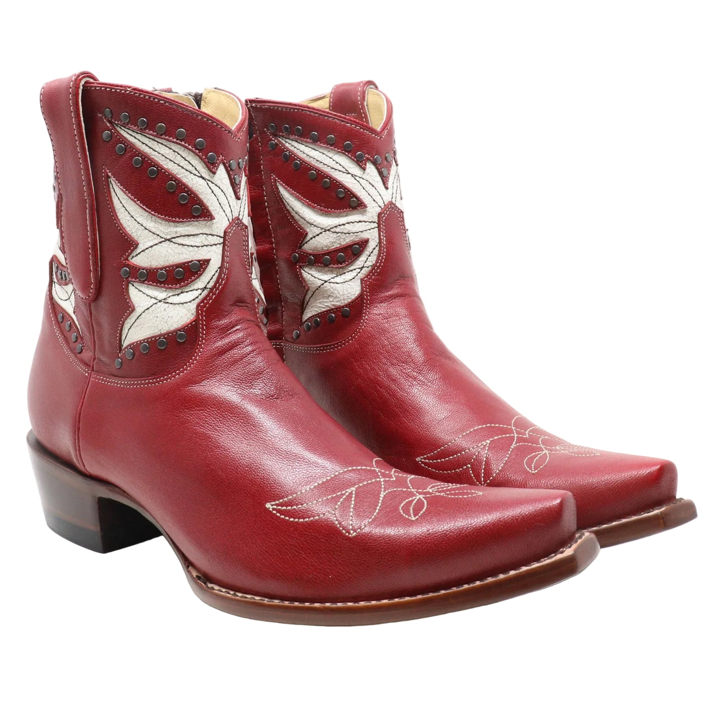 A pair of red leather cowboy boots with white embroidered floral details and dark brown stacked heels, photographed on a white studio background.