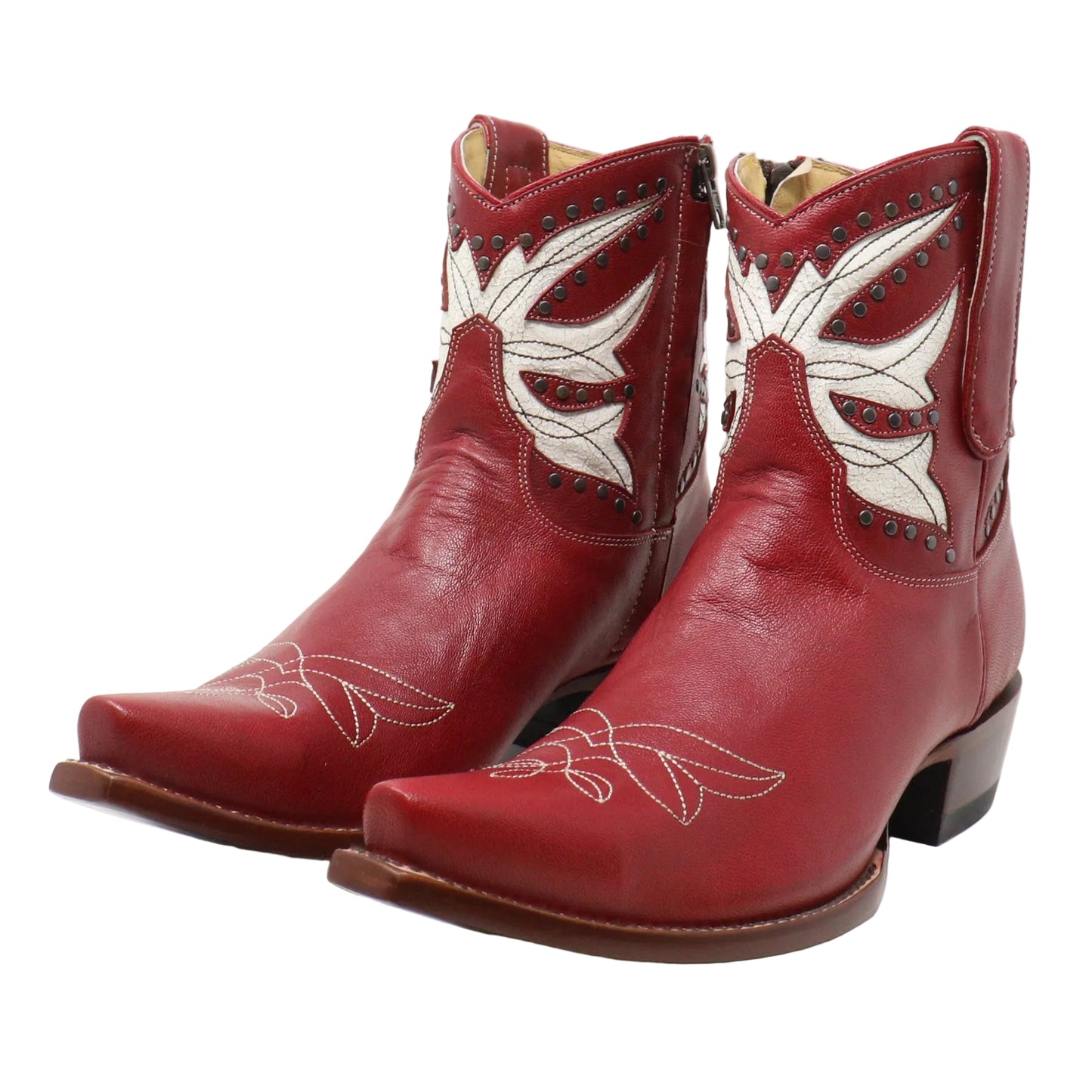 A pair of red leather cowboy boots with white embroidered floral patterns and dark brown heels, photographed on a white studio background.