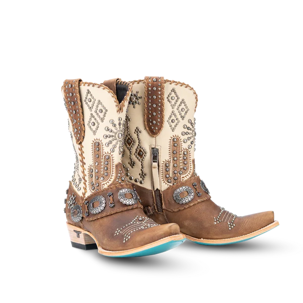 Pair of brown and cream cowboy boots with intricate designs on a white background