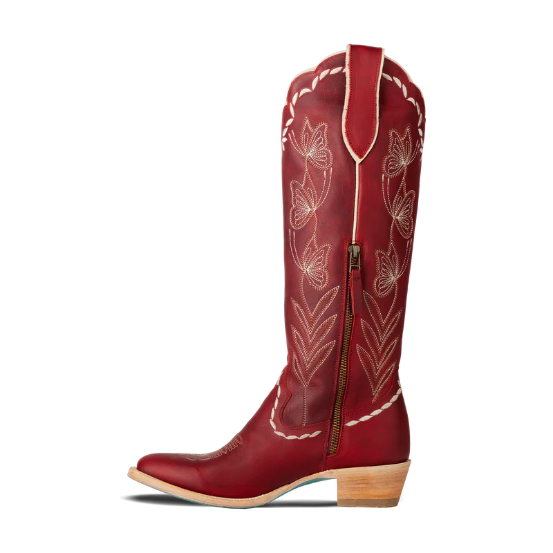 Red cowboy boot with white embroidery on a white background