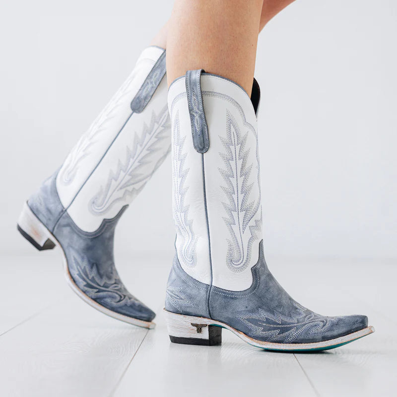 White and blue cowboy boots on a light gray background